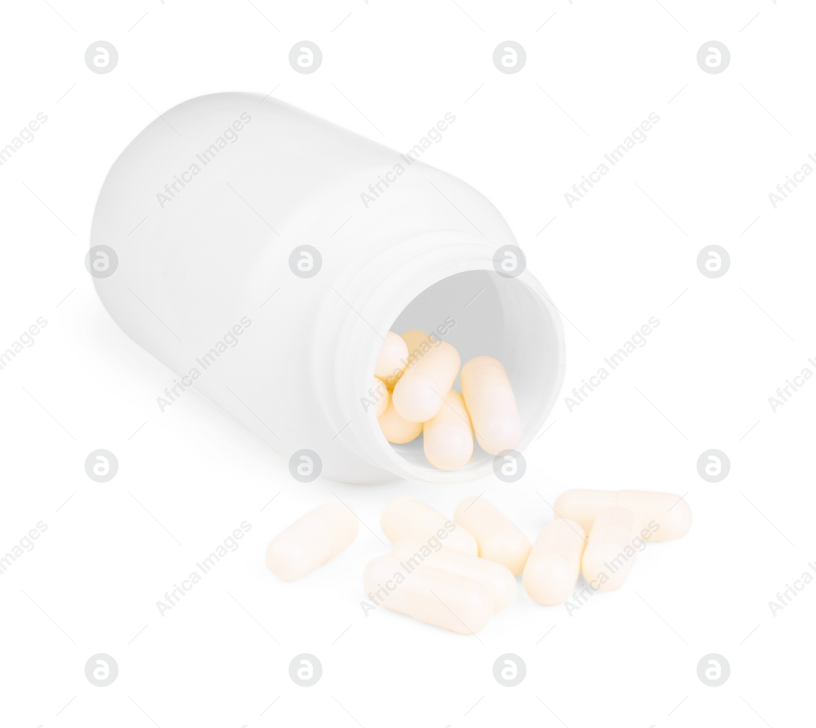 Photo of Vitamin capsules and medical bottle isolated on white