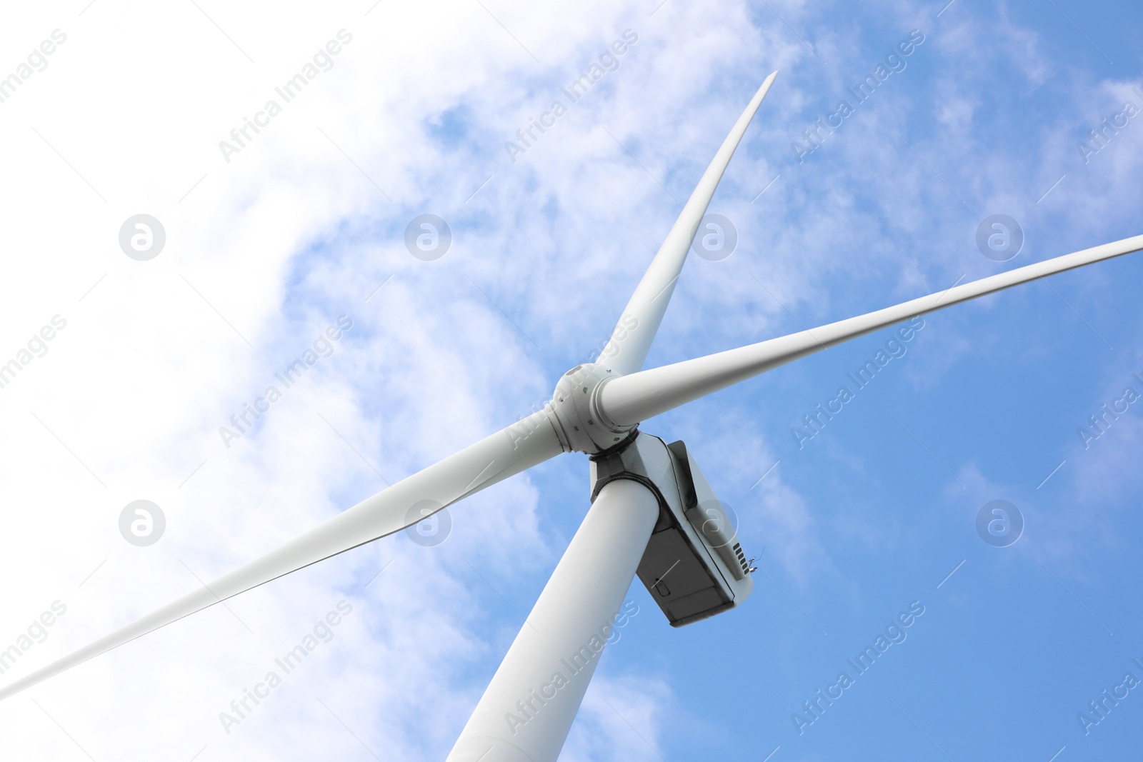 Photo of Wind turbine against beautiful blue sky, low angle view. Alternative energy source