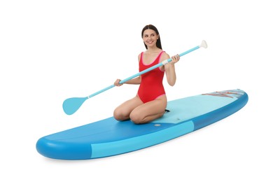 Photo of Happy woman with paddle on blue SUP board against white background