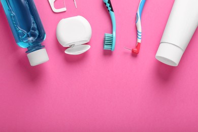 Flat lay composition with dental floss and different teeth care products on pink background, space for text