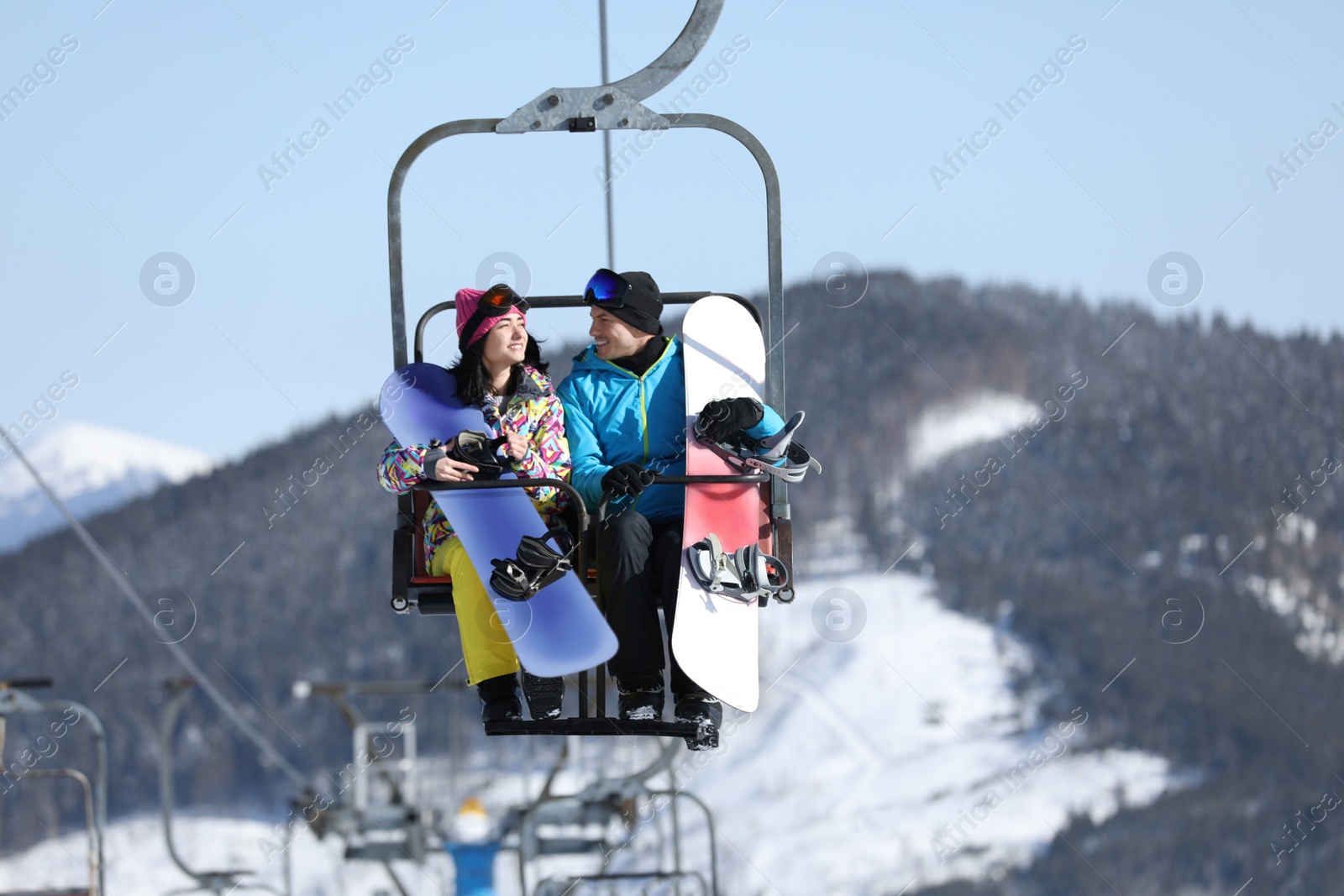 Photo of People using chairlift at mountain ski resort. Winter vacation