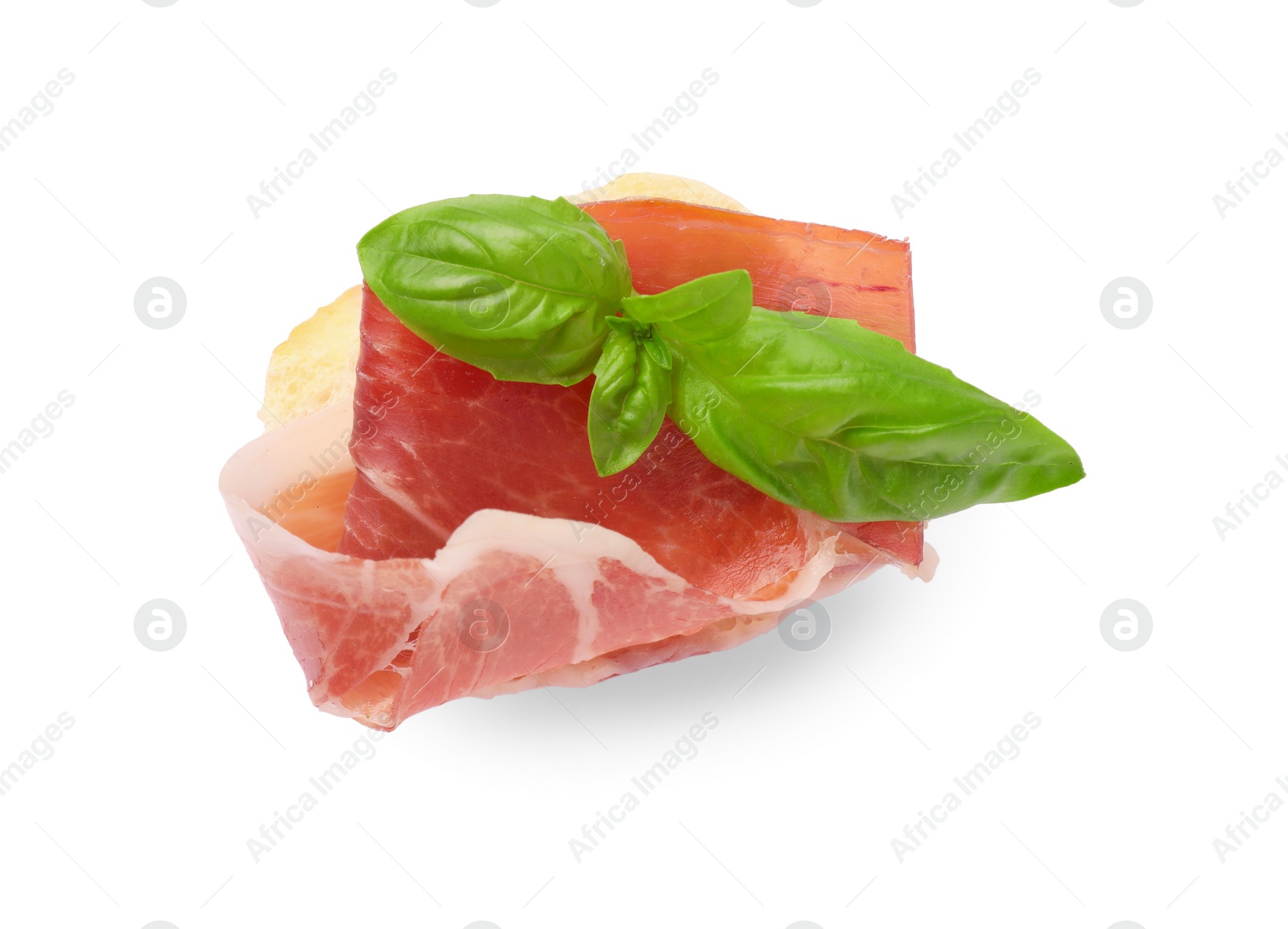 Photo of Tasty sandwich with cured ham and basil leaves isolated on white, top view
