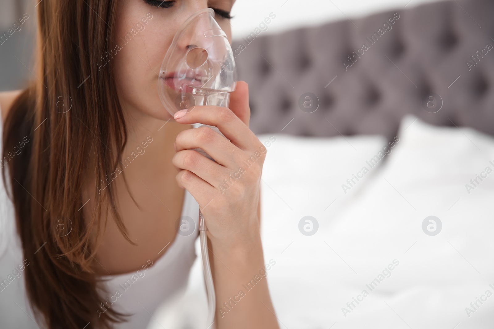 Photo of Woman with asthma machine in bedroom, closeup