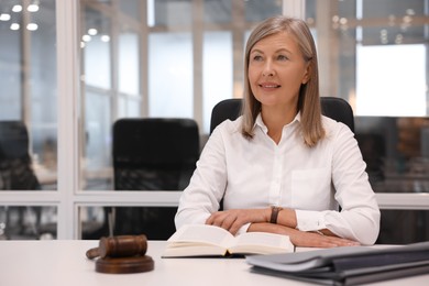 Photo of Portrait of confident lawyer working at table in office, space for text