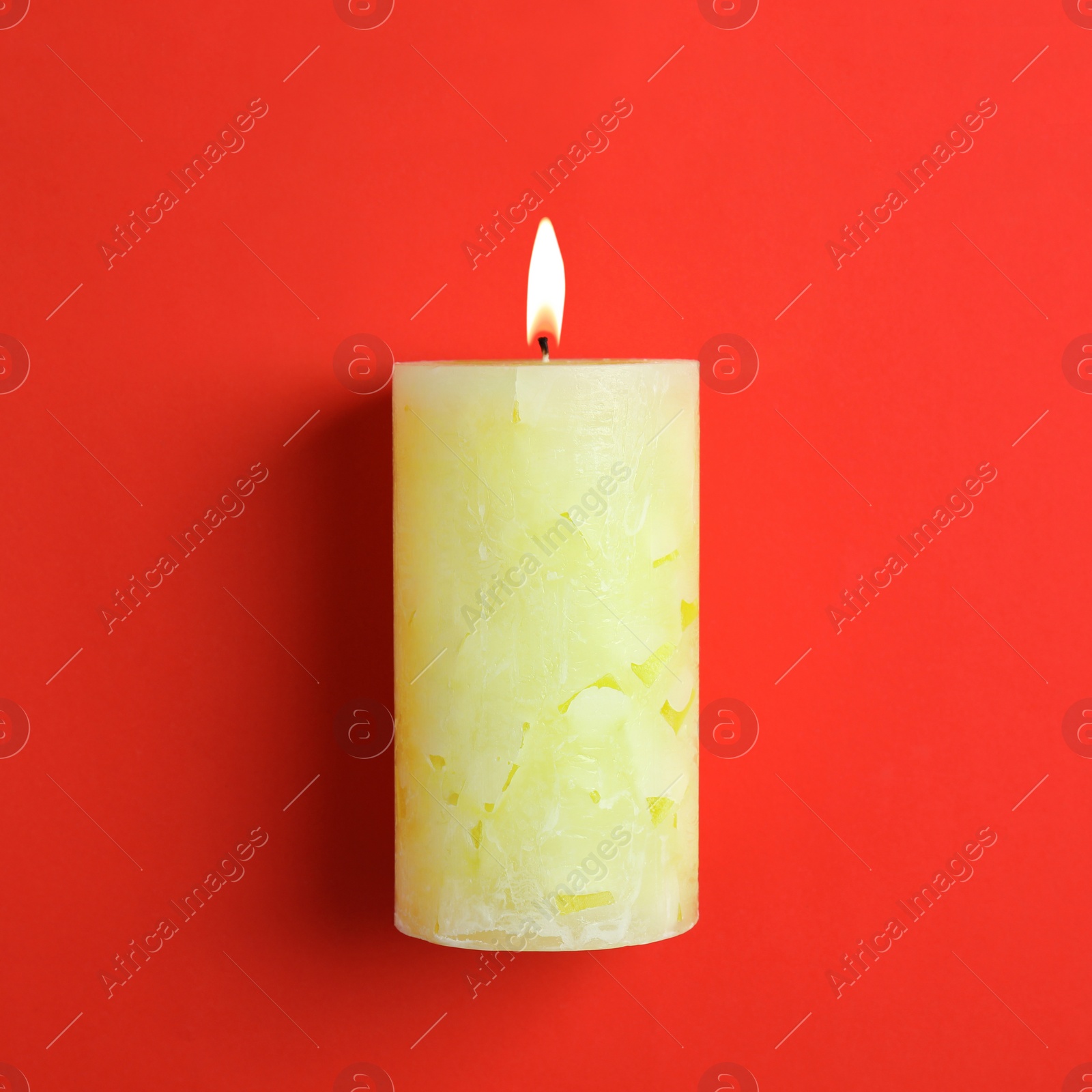 Photo of Alight scented wax candle on color background