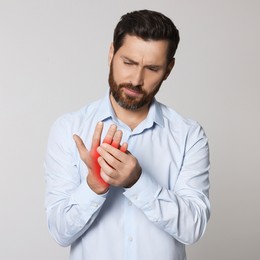 Image of Man suffering from rheumatism on light background