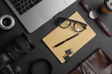 Flat lay composition with professional photographer equipment on dark background