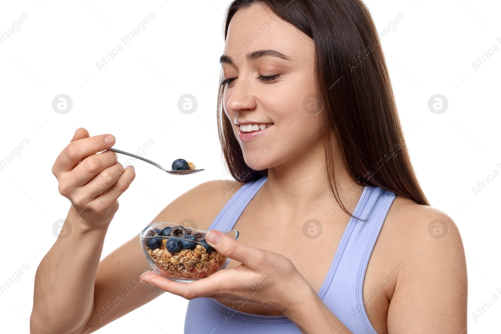 Photo of Happy woman eating tasty granola with fresh berries on white background