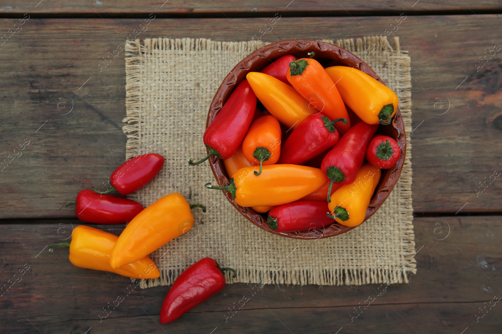 Photo of Ripe bell peppers on wooden table, flat lay