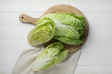 Photo of Fresh ripe Chinese cabbages on white wooden table, flat lay