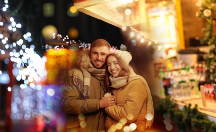 Image of Happy couple spending time at Christmas fair