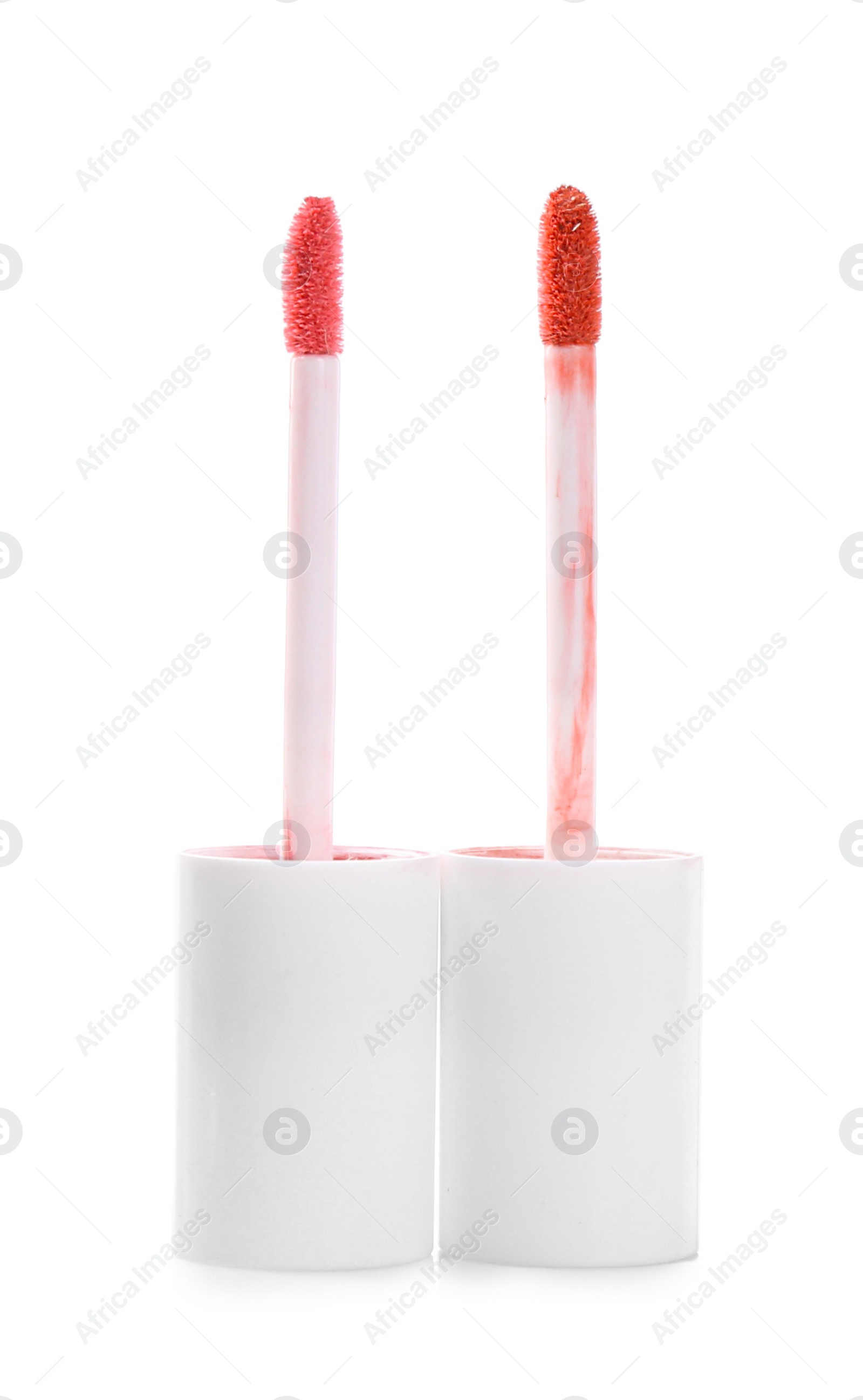 Photo of Two lip gloss applicators isolated on white