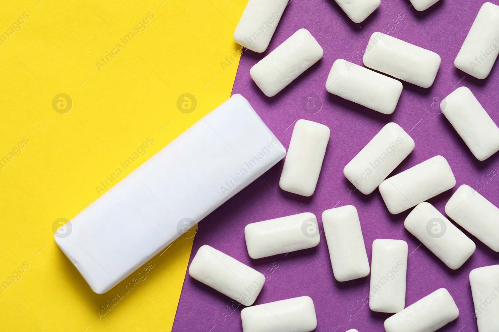 Photo of Pack with tasty chewing gums on color background, flat lay. Space for text