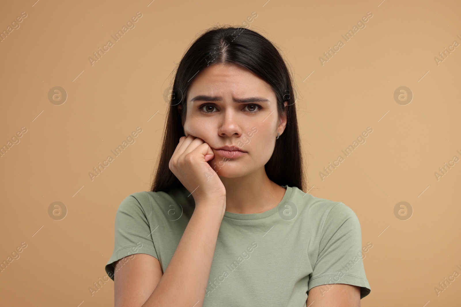 Photo of Portrait of resentful woman on beige background