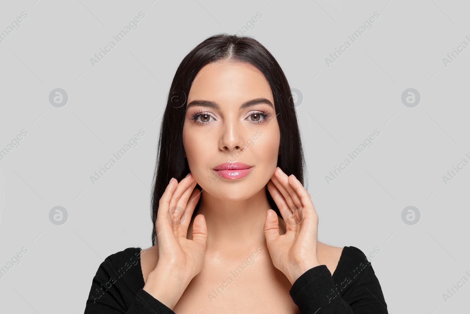 Photo of Portrait of beautiful young woman on light grey background