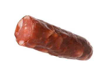 Photo of Piece of thin dry smoked sausage isolated on white