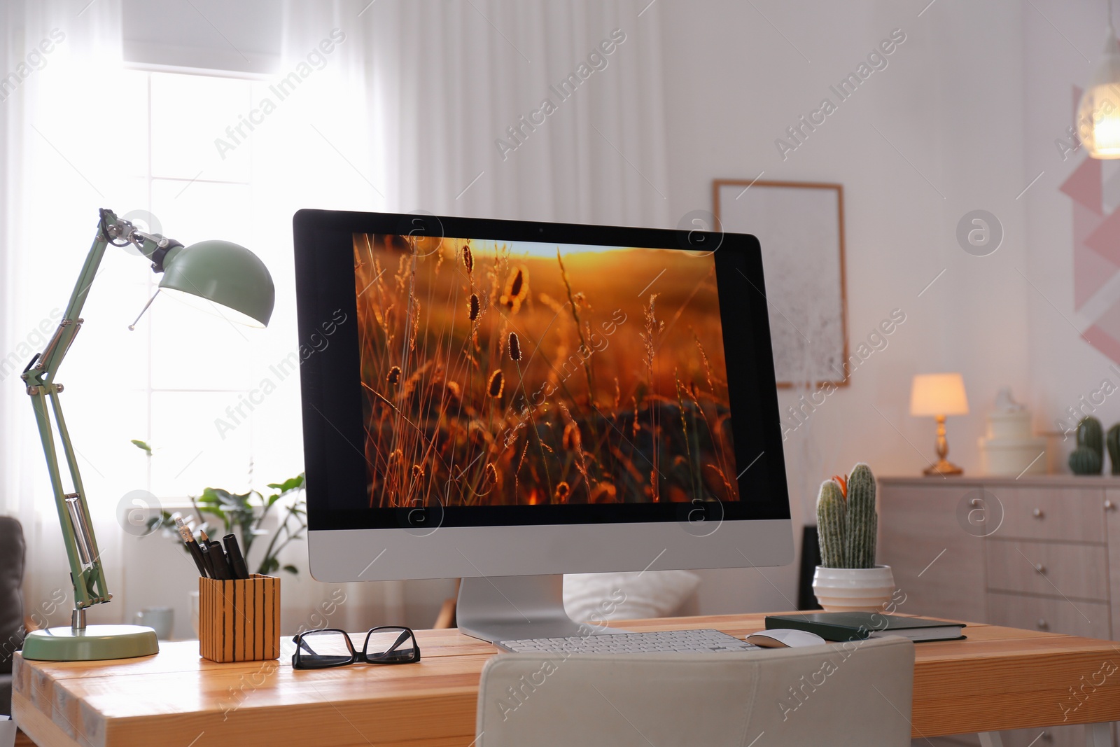 Photo of Comfortable workplace with modern computer on desk. Home office