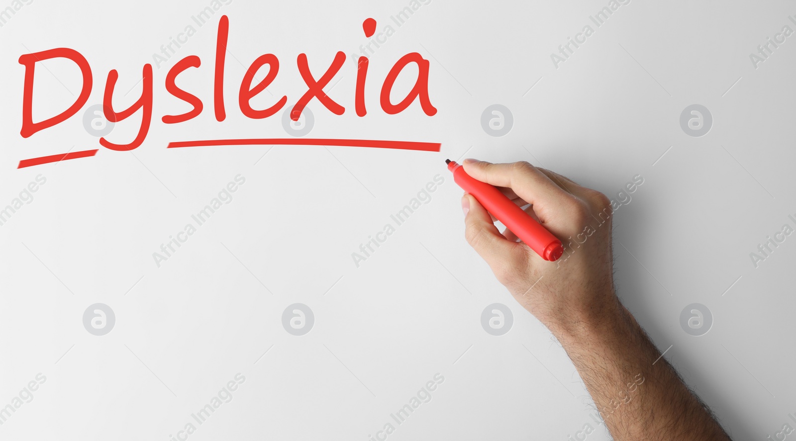 Image of Man writing word Dyslexia on white background, closeup. Banner design