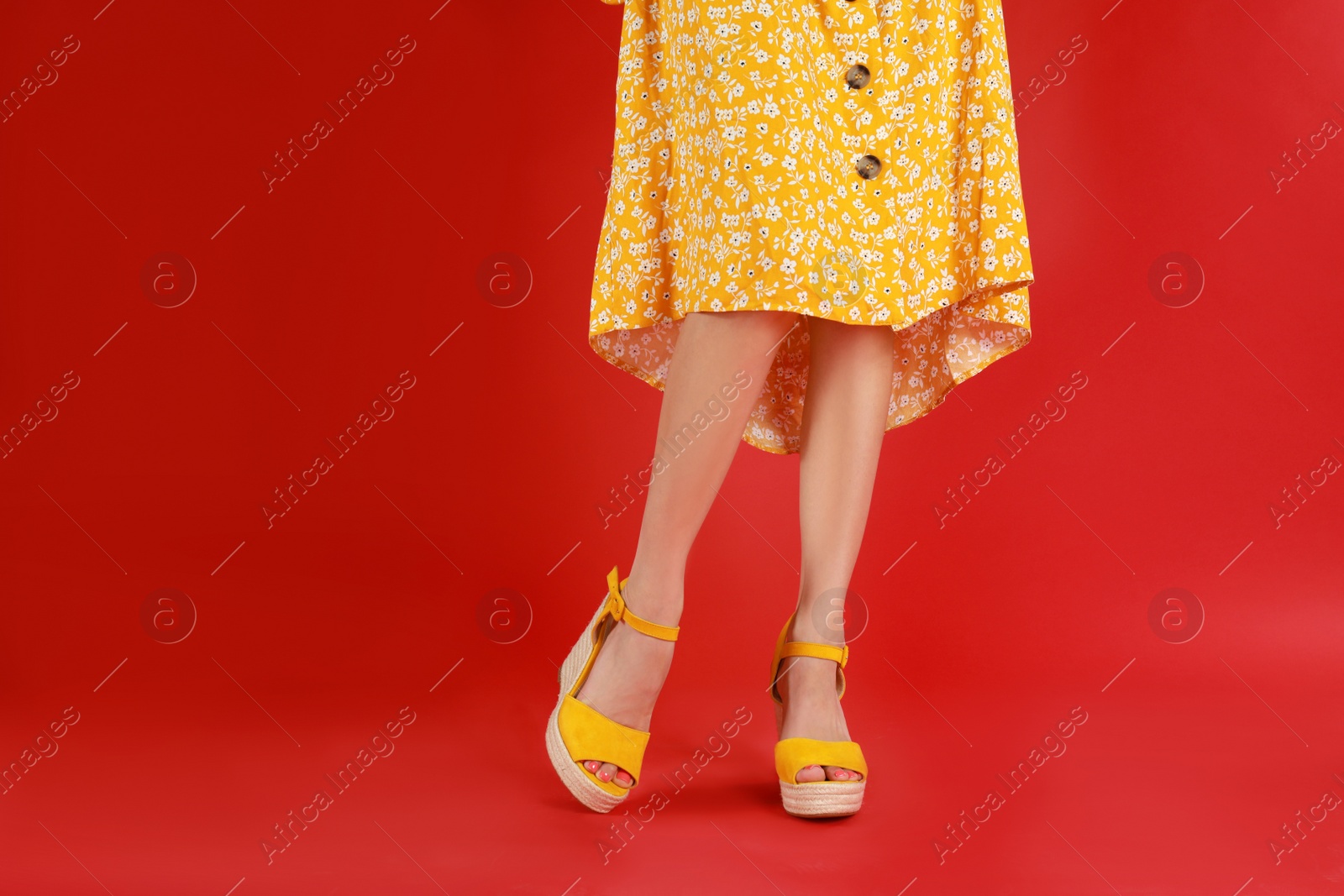 Photo of Woman in stylish shoes on red background