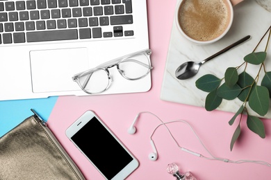 Photo of Flat lay composition with laptop and beauty blogger's stuff on pink background