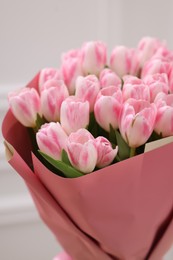 Beautiful bouquet of fresh pink tulips on blurred background, closeup