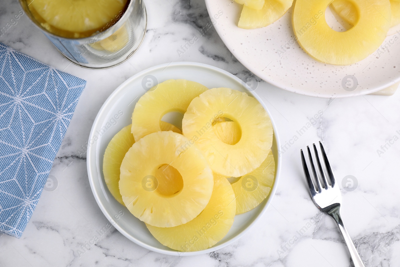 Photo of Flat lay composition with canned pineapple pieces on white wooden table