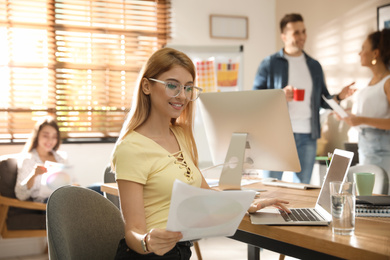 Portrait of happy female designer in office