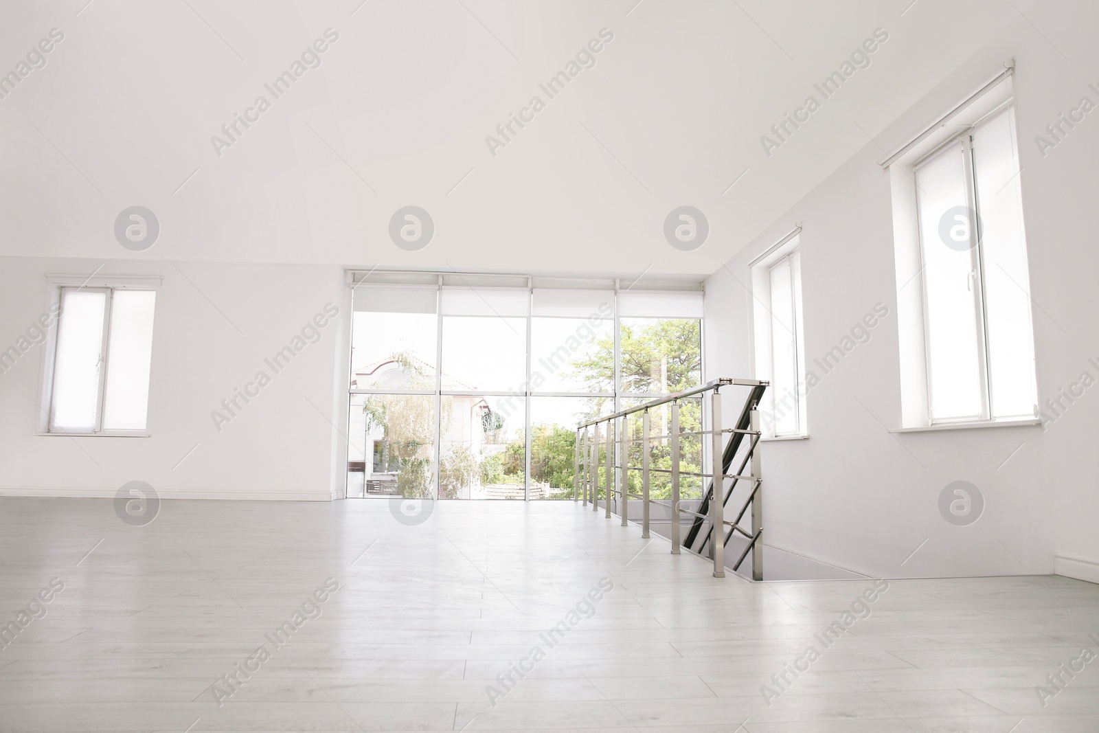 Photo of Empty room with windows and laminated floor