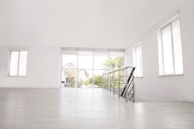 Photo of Empty room with windows and laminated floor