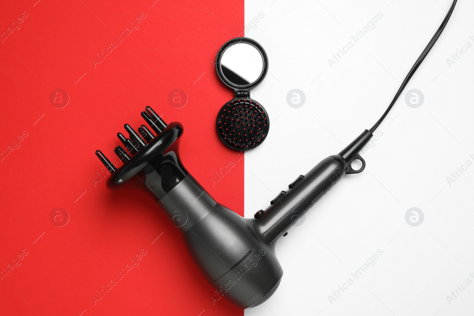 Photo of Hair dryer and brush on color background, flat lay. Professional hairdresser tool