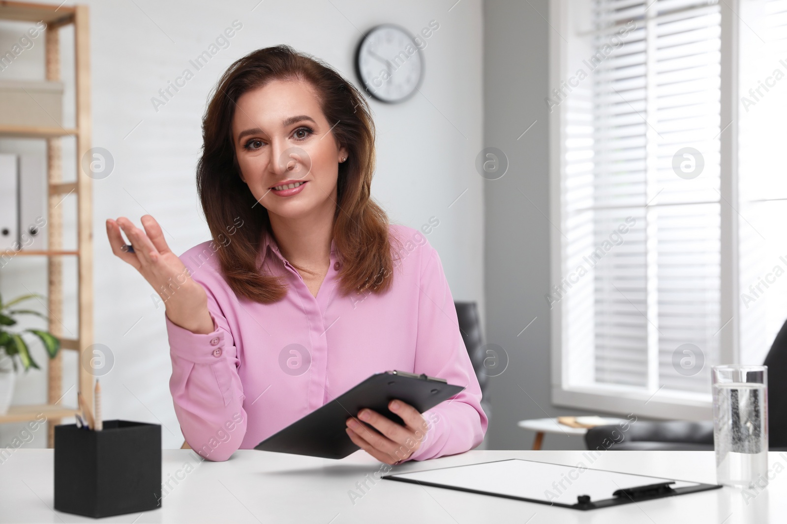 Photo of Portrait of psychotherapist at white table in office