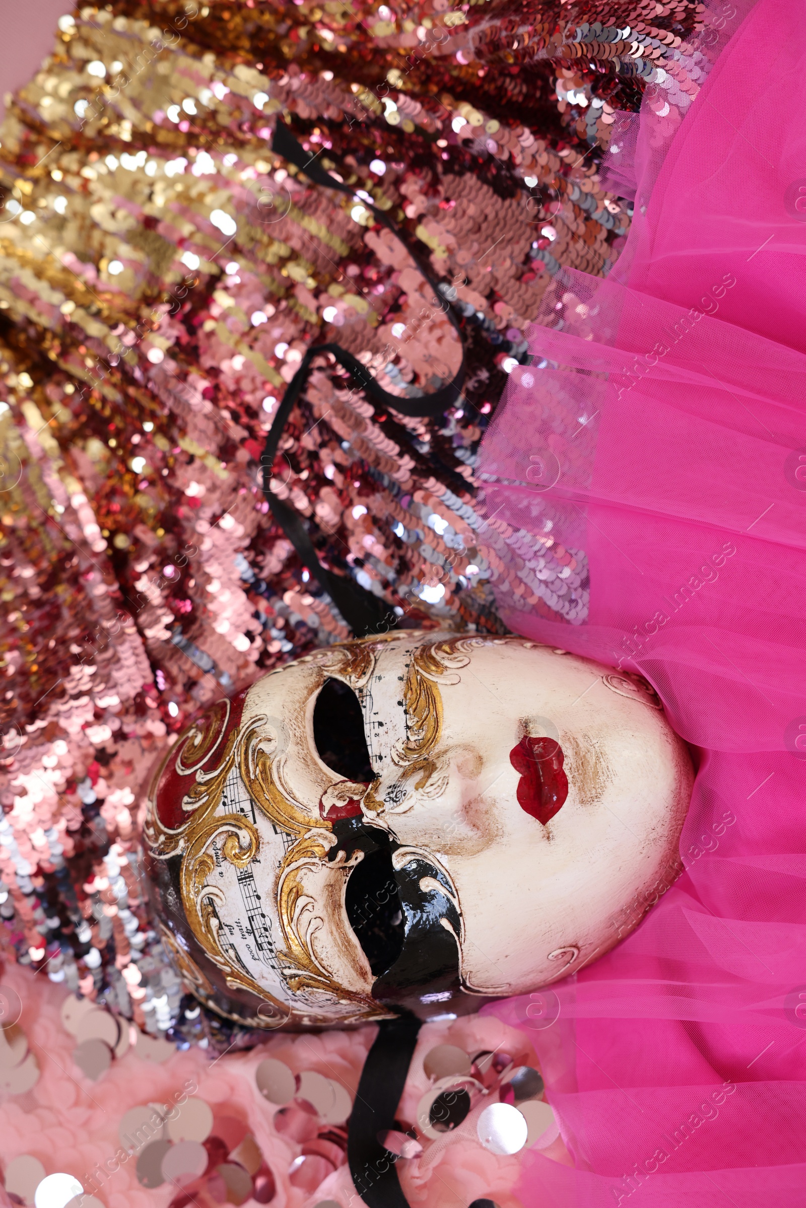 Photo of Carnival mask and beautiful pink costume with sequins, above view