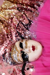 Photo of Carnival mask and beautiful pink costume with sequins, above view