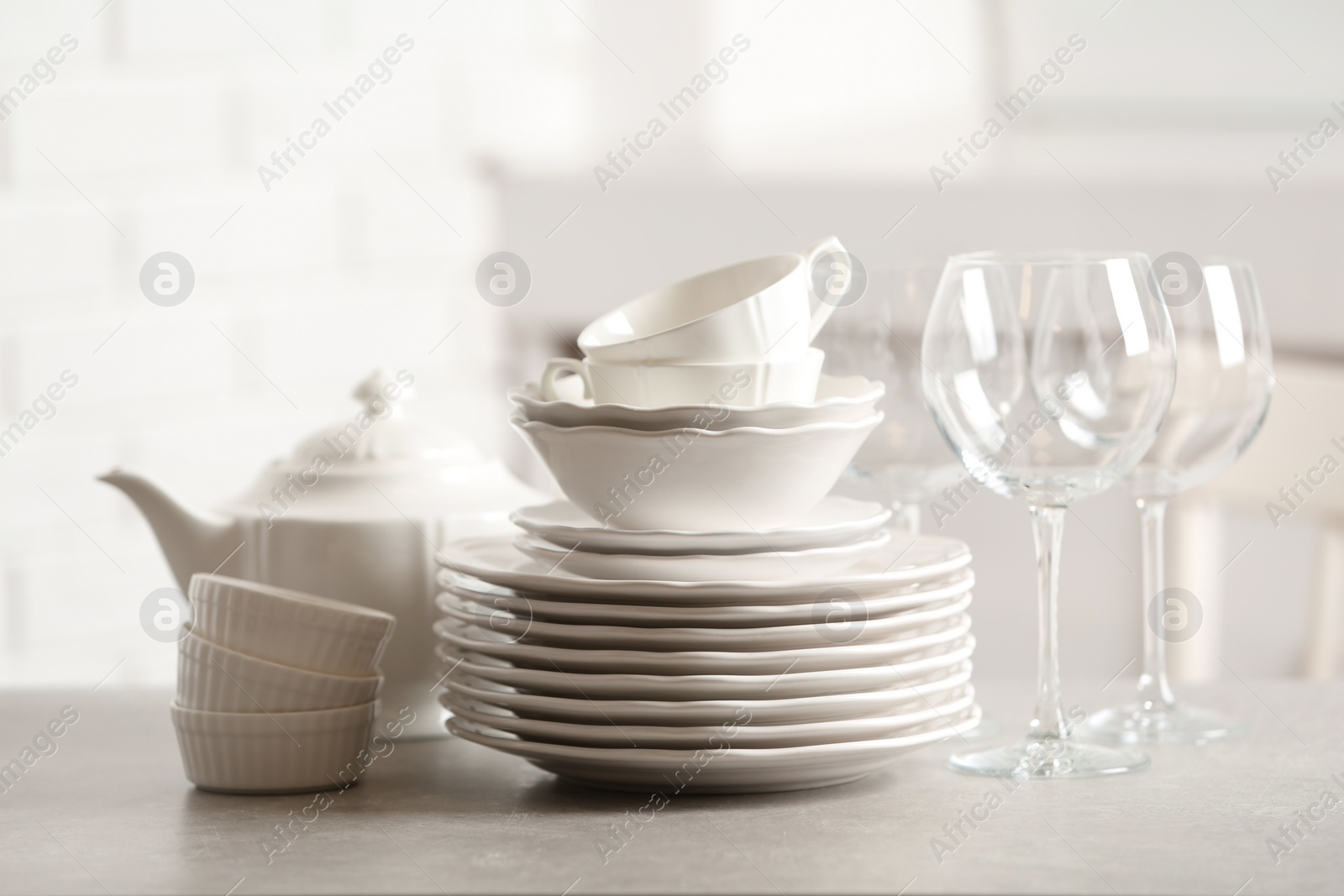 Photo of Set of clean dishes against blurred background
