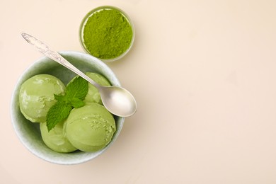 Photo of Tasty matcha ice cream, spoon and powder on beige table, flat lay. Space for text
