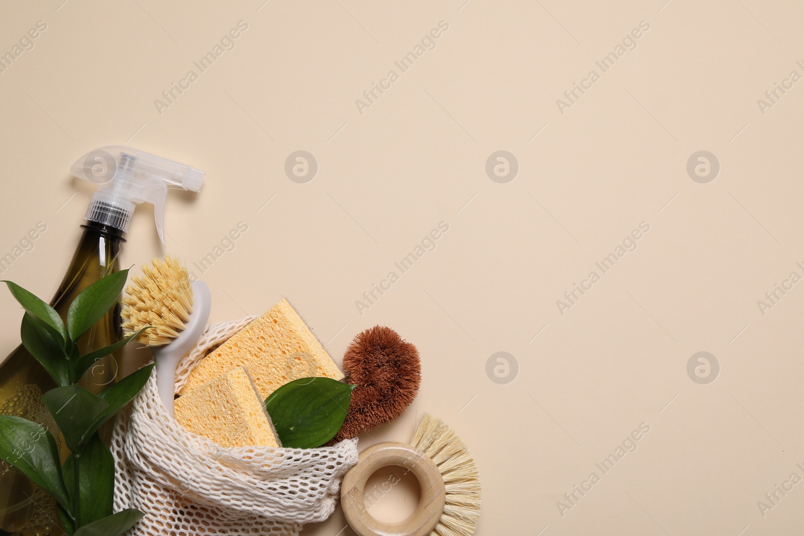 Photo of Flat lay composition with different cleaning supplies on beige background. Space for text