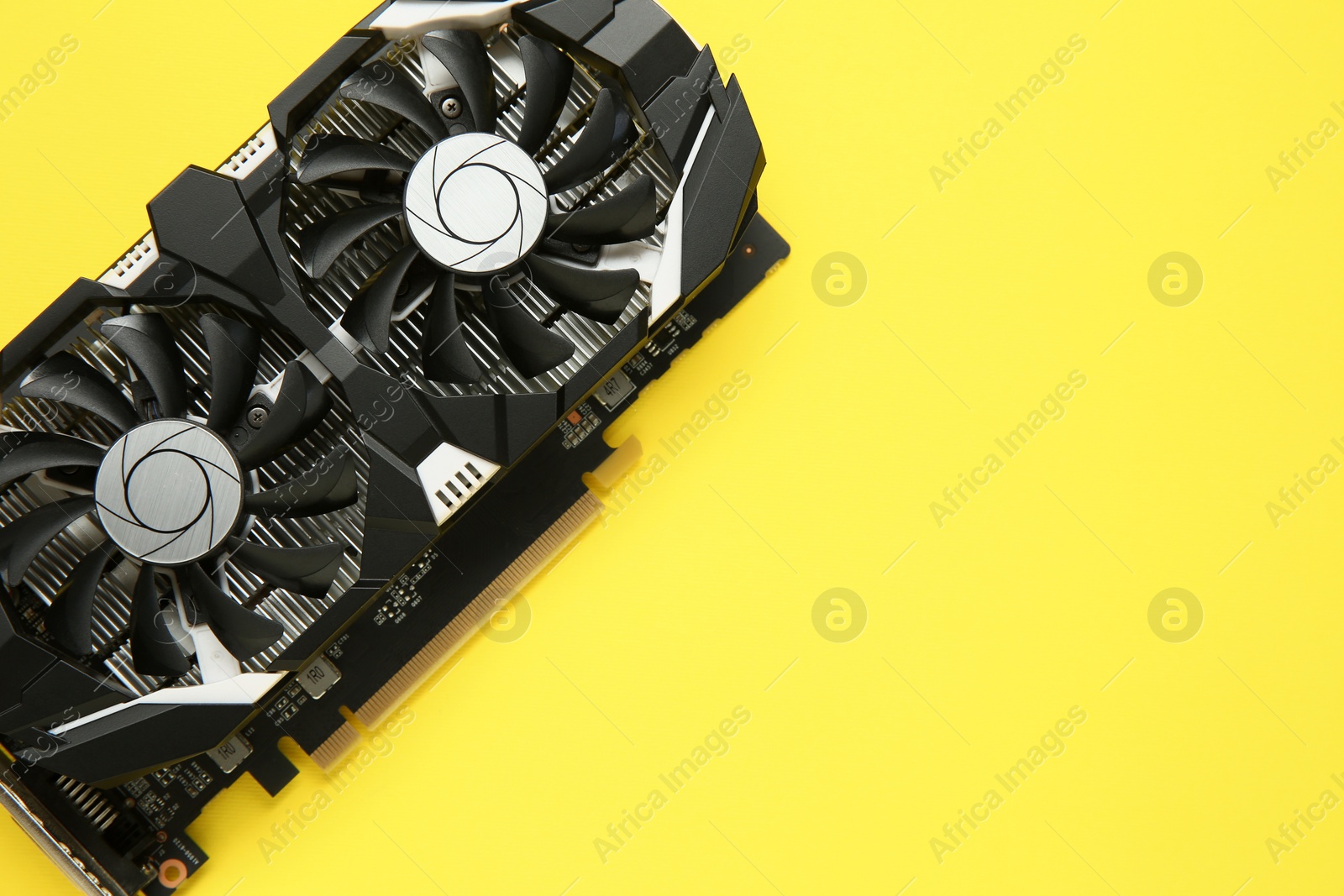 Photo of Computer graphics card on yellow background, top view. Space for text