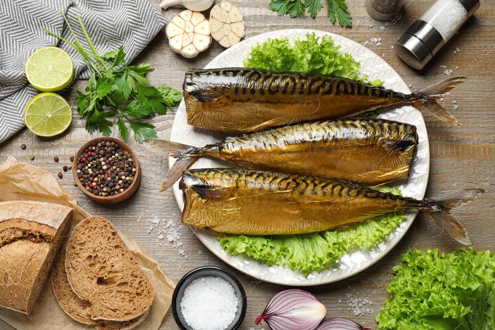 Photo of Flat lay composition with tasty smoked fish on wooden table