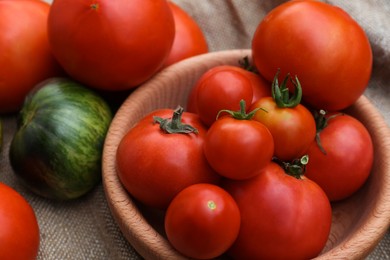 Many different ripe tomatoes on table, closeup