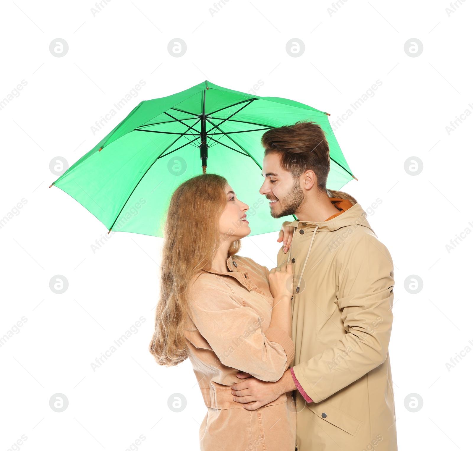 Photo of Young romantic couple with bright umbrella on white background