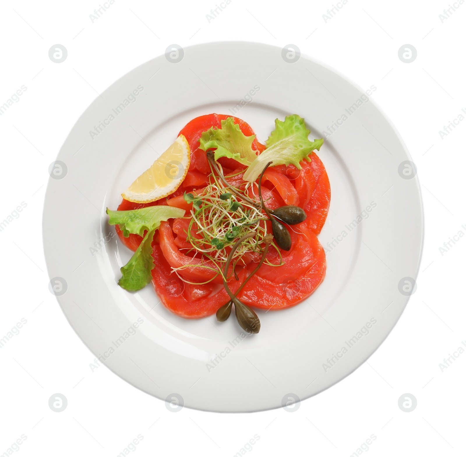 Photo of Salmon carpaccio with capers, lettuce, microgreens and lemon isolated on white, top view