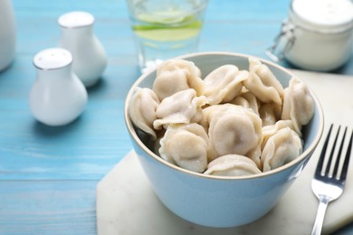 Photo of Delicious dumplings on turquoise wooden table, closeup
