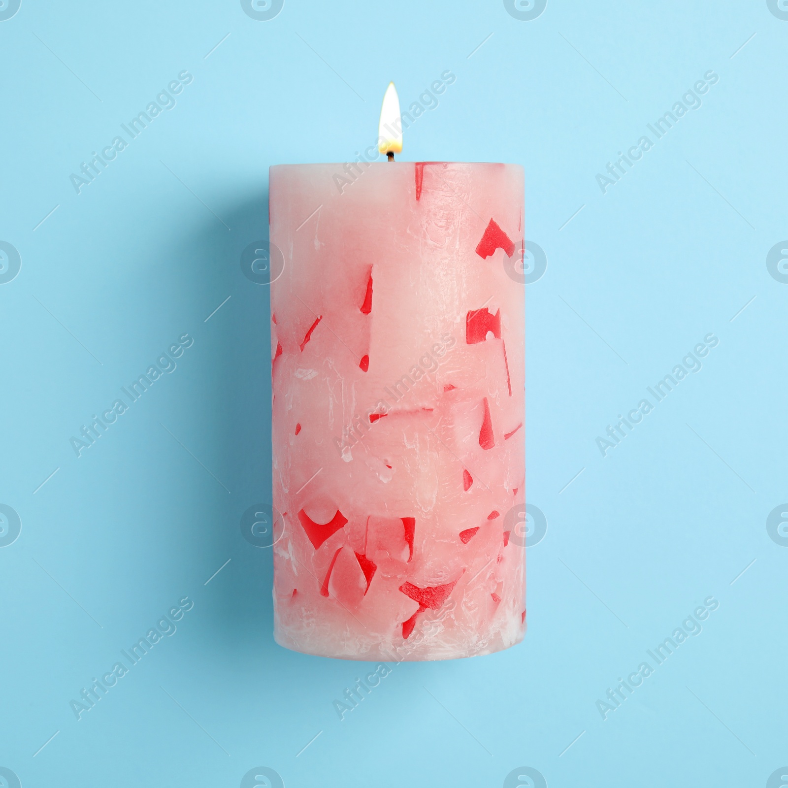 Photo of Alight scented wax candle on color background