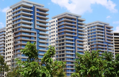 View of buildings and trees on sunny day