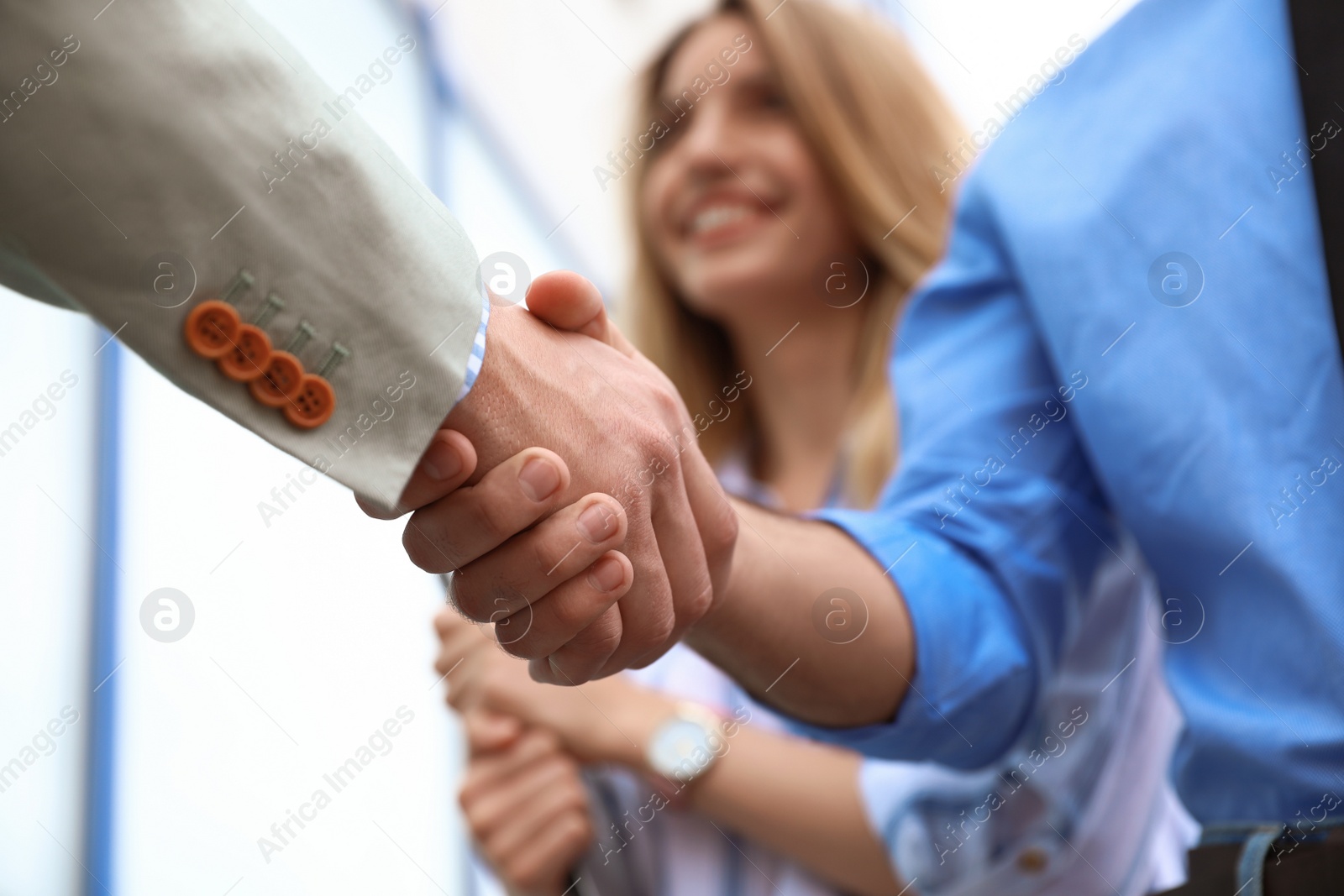 Photo of Business partners shaking hands after meeting, closeup