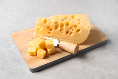 Photo of Tasty fresh cheese with fork on grey table
