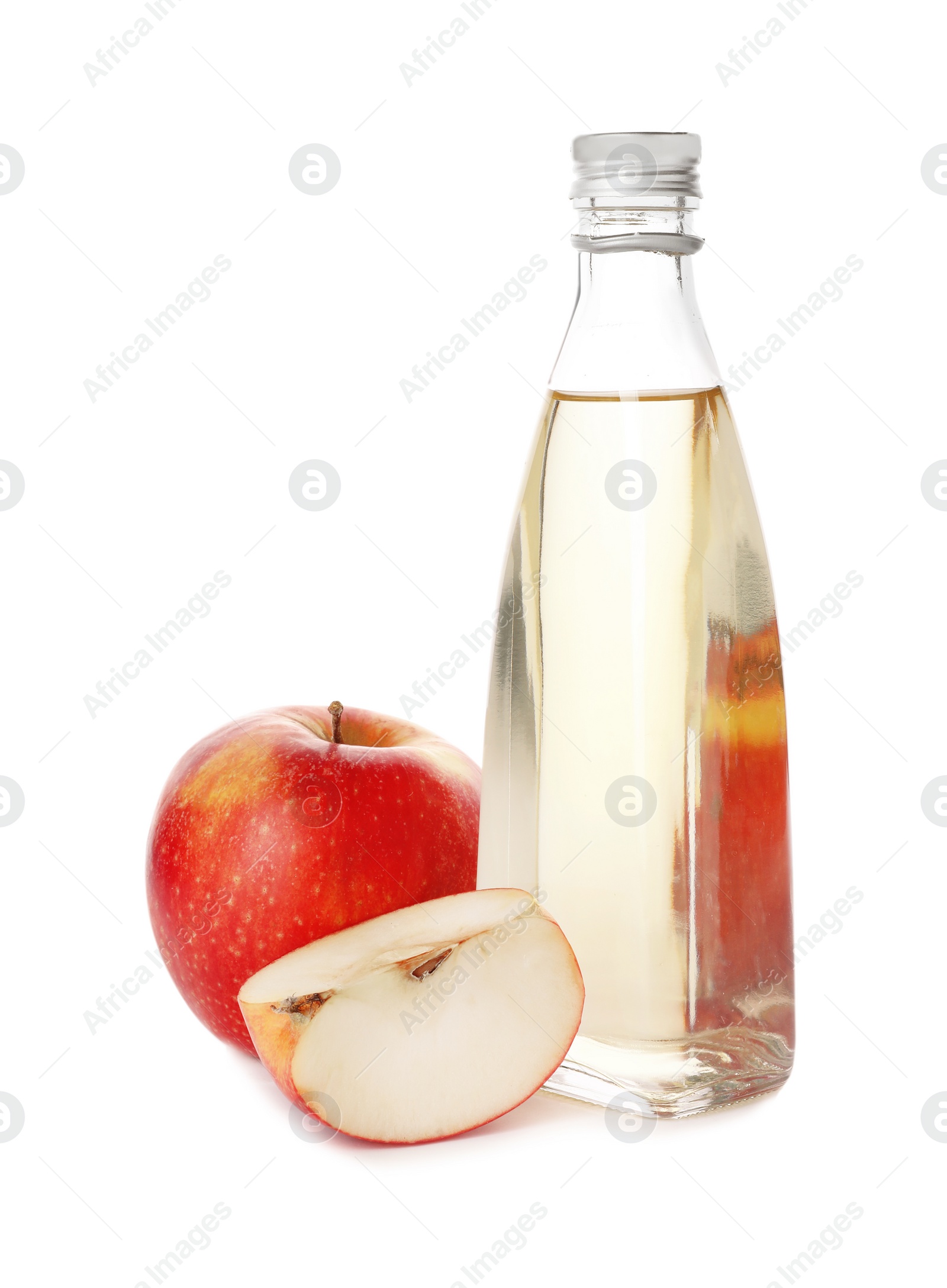 Photo of Glass bottle of vinegar and fresh apples on white background