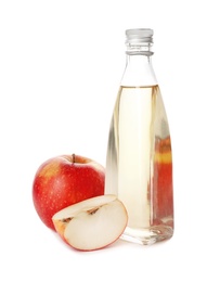 Photo of Glass bottle of vinegar and fresh apples on white background