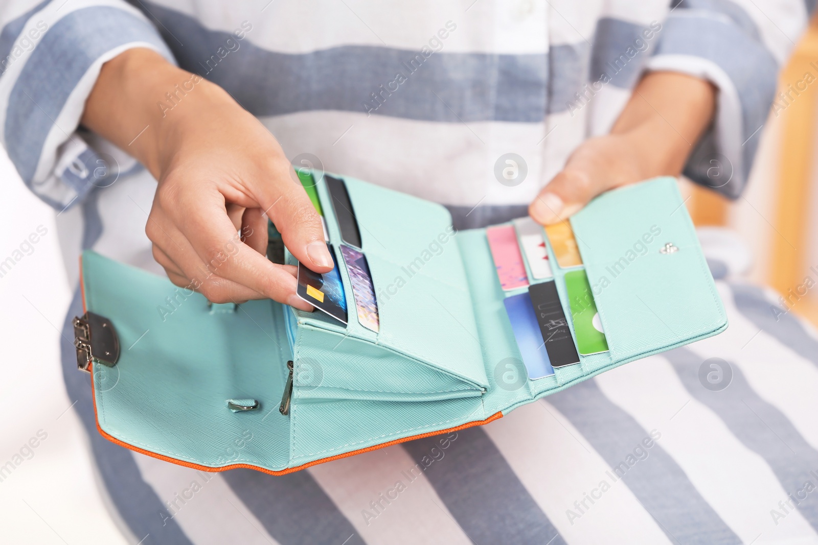 Photo of Woman taking out credit card from stylish wallet, closeup