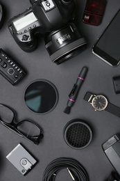 Flat lay composition with equipment for professional photographer on dark background